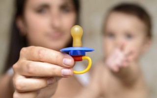mother shows Pacifier For the baby